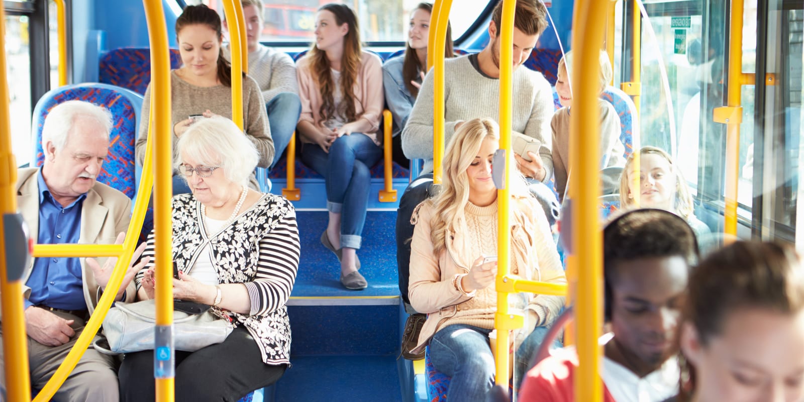 Passengers of different ages seated on a public bus